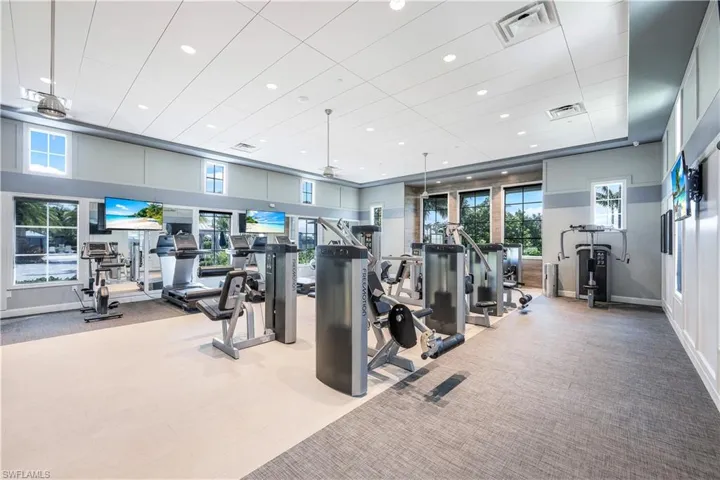Exercise room with recessed lighting and a high ceiling