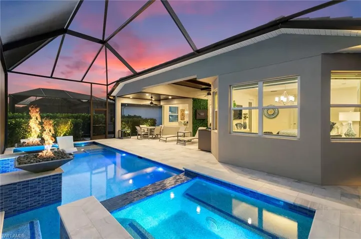 View of pool with a sunroom, a lanai, a patio area, and a pool with connected hot tub
