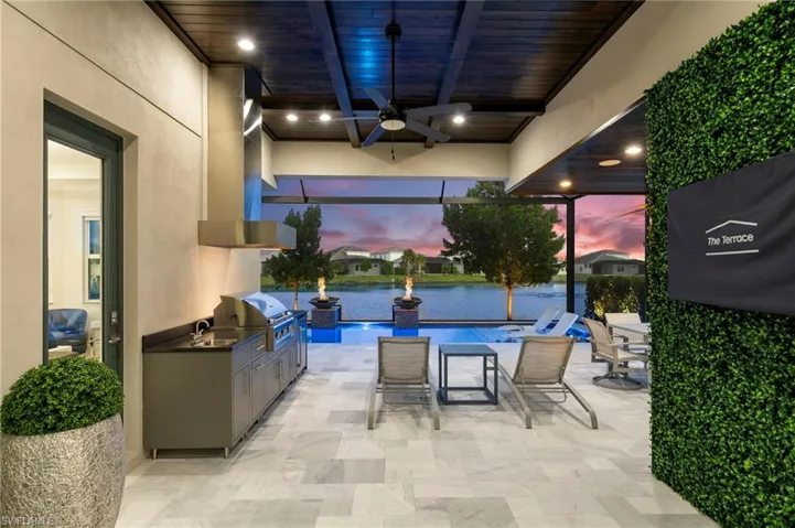 View of patio / terrace featuring a ceiling fan and an outdoor kitchen