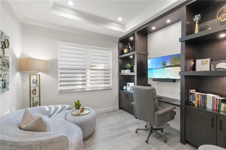 Office featuring a tray ceiling, crown molding, wood tiled floors, and recessed lighting