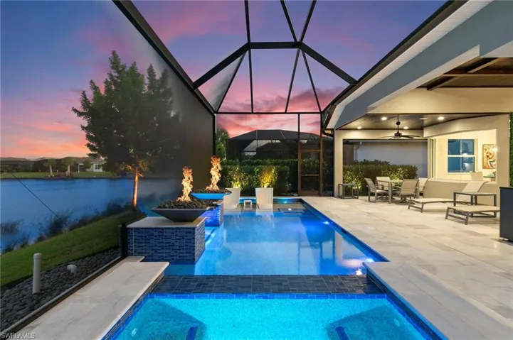 View of swimming pool with a lanai, a sunroom, a patio area, and outdoor dining space