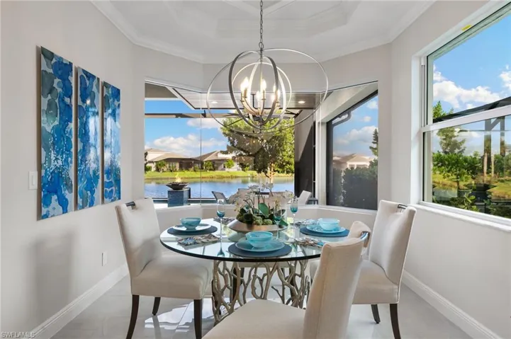 Dining area with a chandelier and a water view