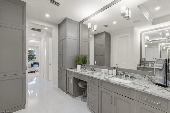 Full bathroom with vanity, crown molding, and recessed lighting