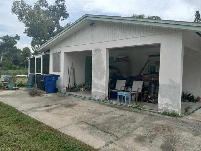 Back of house featuring an outdoor structure and a garage