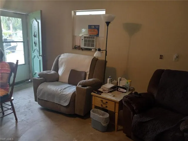 Living area featuring cooling unit and concrete flooring