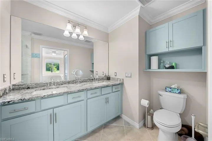 Dual vanity with a stone countertop and integrated sinks