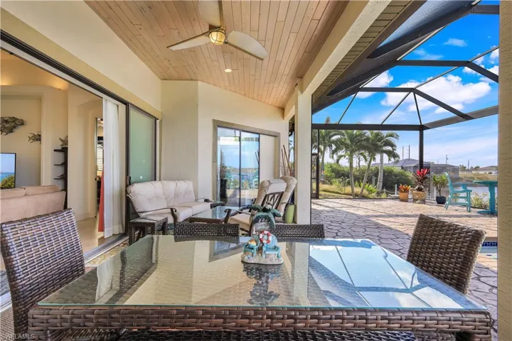 View of patio / terrace with an outdoor hangout area, ceiling fan, and a lanai