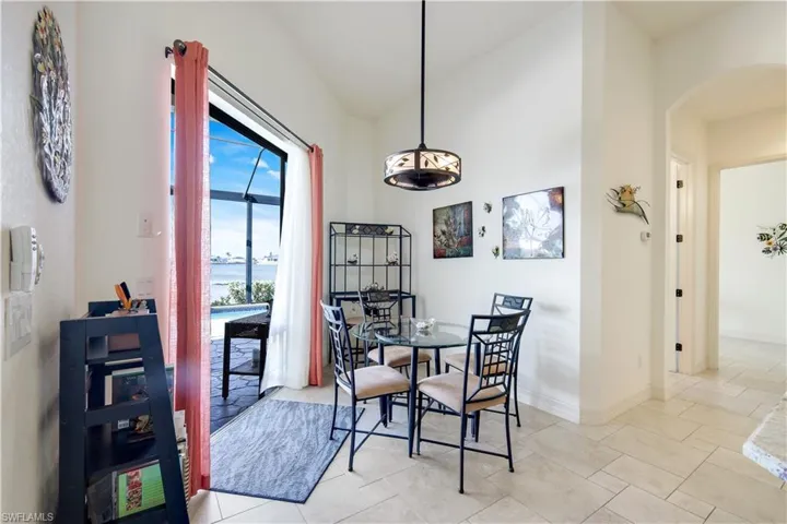 Tiled dining space with lofted ceiling