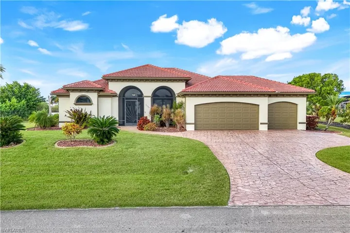 Mediterranean / spanish-style home featuring a front lawn and a garage
