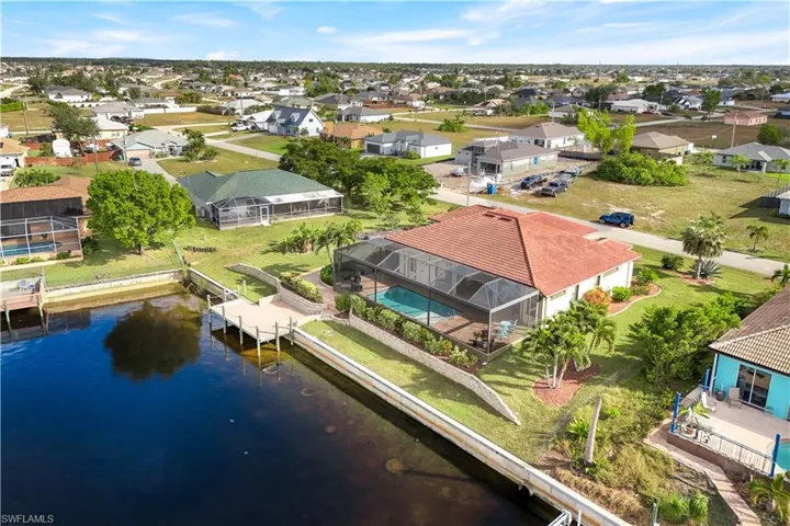 Birds eye view of property with a water view