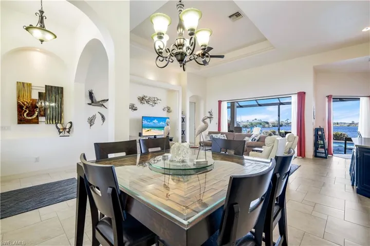 Dining space featuring a chandelier and a tray ceiling