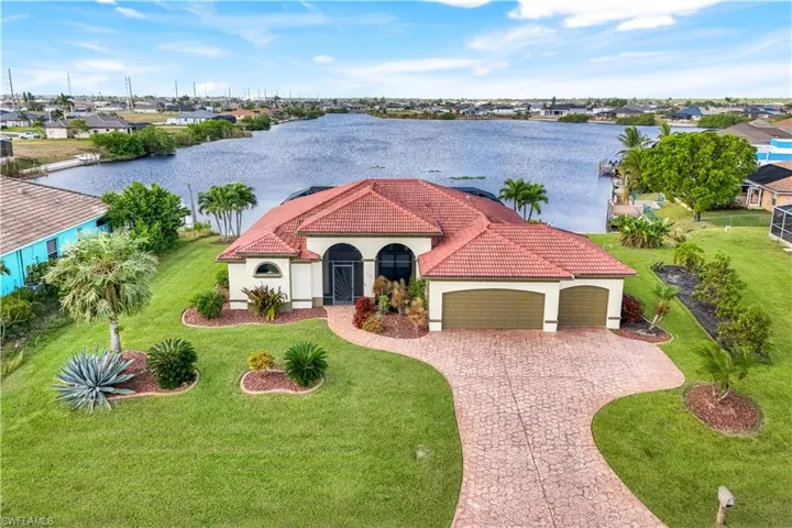 Mediterranean / spanish-style house with a water view and a garage
