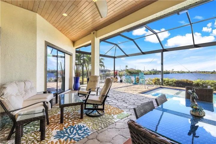 View of patio / terrace featuring a water view and a lanai