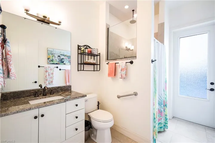 Bathroom with tile patterned flooring, vanity, toilet, and a shower with curtain