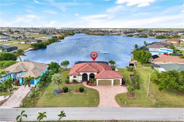 Birds eye view of property with a water view