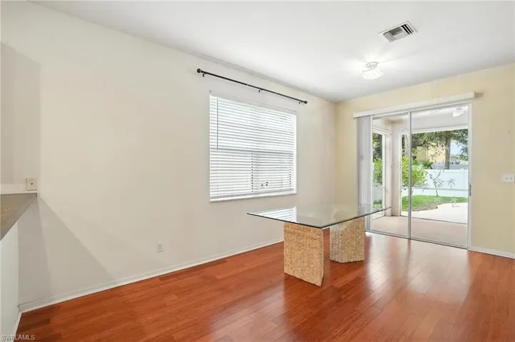 Unfurnished dining area with wood-type flooring and baseboards