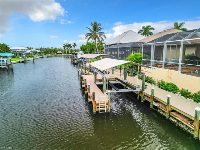 Dock area with boat lift and a water view