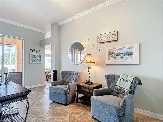 Sitting room featuring crown molding and baseboards