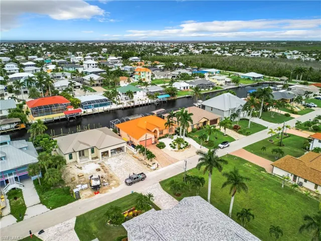 Aerial perspective of suburban area featuring a nearby body of water