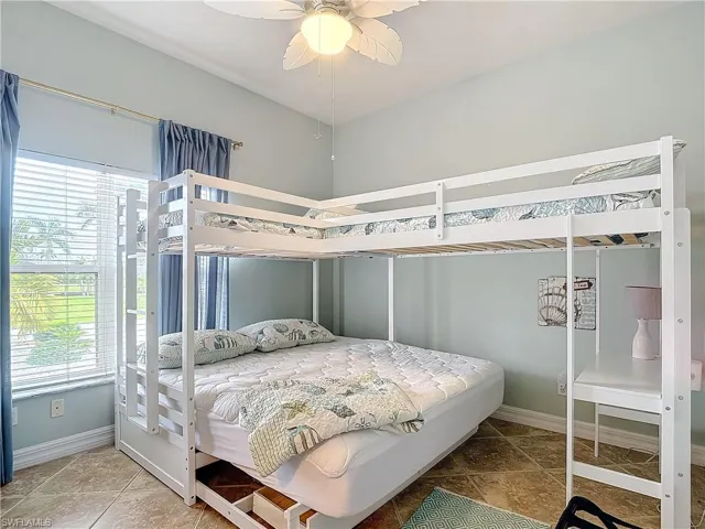 Bedroom with baseboards and ceiling fan