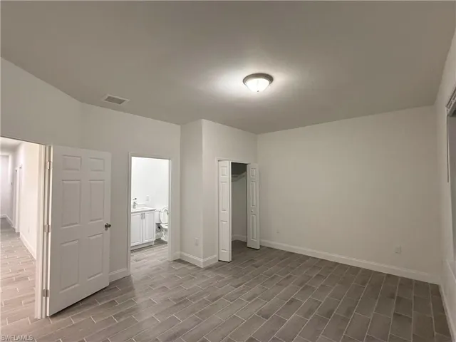Unfurnished bedroom with a closet and light wood-style flooring