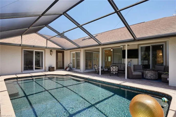 Pool with an outdoor living space patio