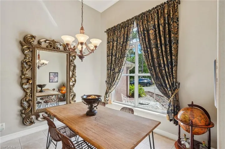 Dining area featuring a chandelier and light tile patterned flooring