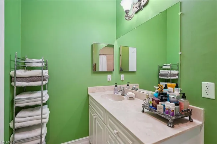 Bathroom with vanity and curtained shower