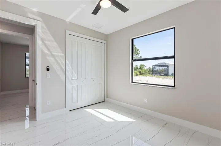 Unfurnished bedroom featuring a closet, ceiling fan, and light hardwood / wood-style flooring