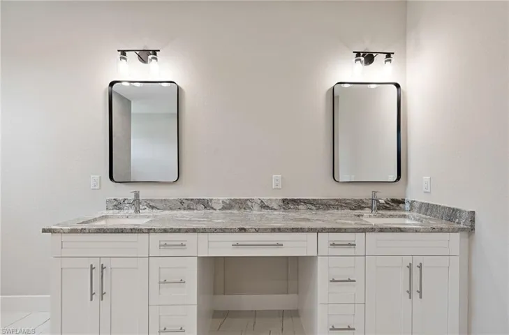 Bathroom with tile floors and double sink vanity
