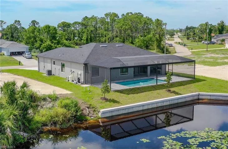 Back of house featuring a lawn, a patio area, and central air condition unit