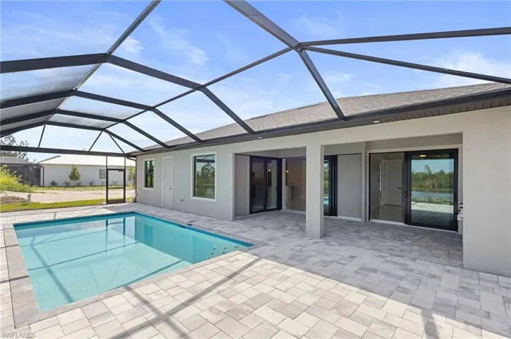 View of pool featuring a patio area and a lanai