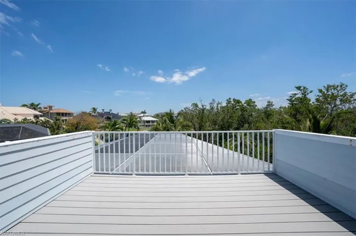 Wooden deck featuring a residential view from primary bedroom.