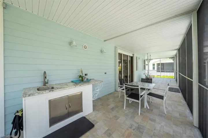 View of patio featuring a sink, an outdoor kitchen, and outdoor dining area
