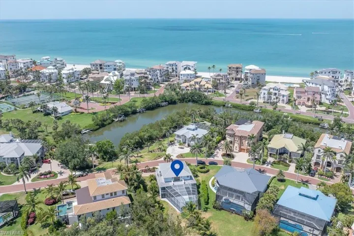 Aerial view of property and surrounding area with a large body of water and nearby suburban area