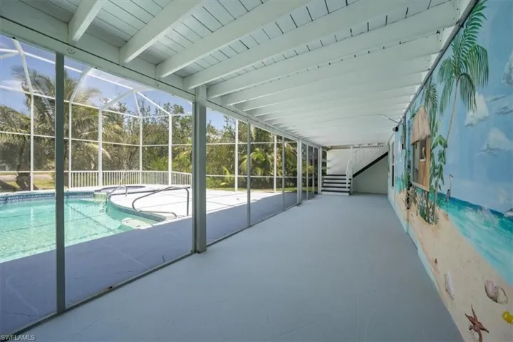 Sunroom with a pool with a hand painted mural.