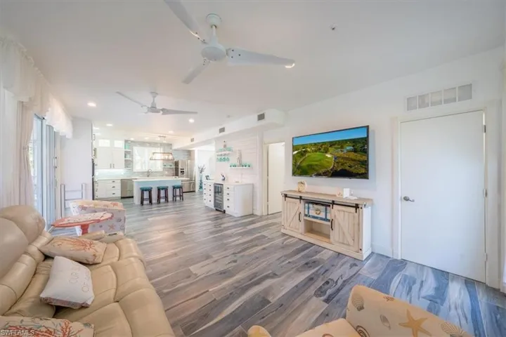 Living room featuring a ceiling fan, light wood-style floors, and recessed lighting