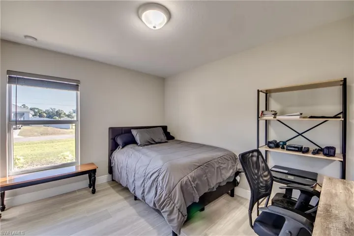 Bedroom featuring light wood-style floors and a desk