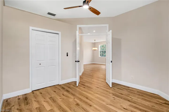 Unfurnished bedroom featuring baseboards, light wood-style floors, and visible vents
