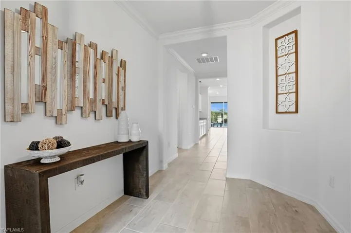 Corridor featuring wood tiled floors, ornamental molding, and recessed lighting