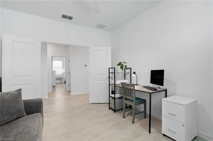 Office with wood tiled floors and a ceiling fan