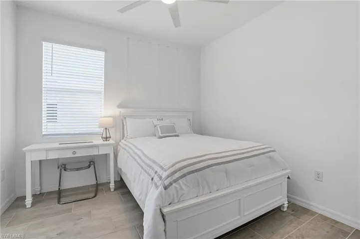 Bedroom featuring ceiling fan and wood finish floors