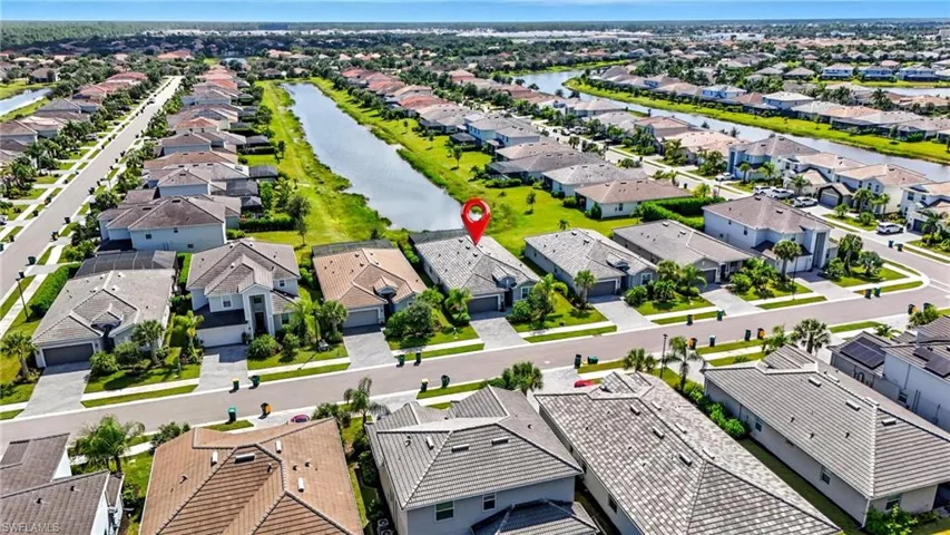 Aerial view of residential area featuring a nearby body of water