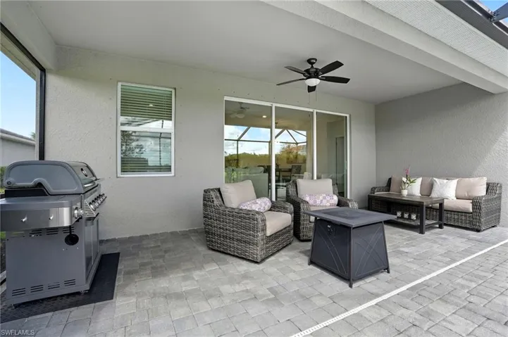 View of patio featuring outdoor lounge area, a ceiling fan, and area for grilling