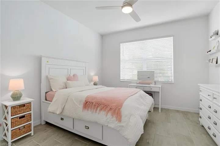 Bedroom with wood finish floors and a ceiling fan