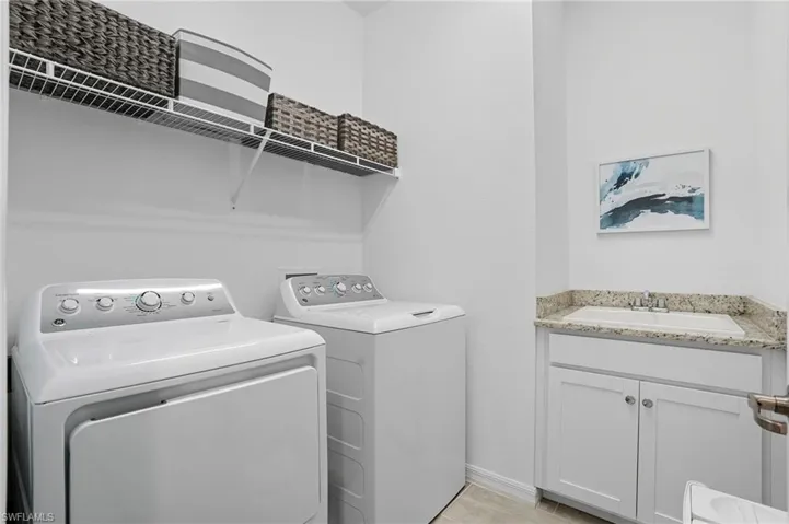 Laundry room with independent washer and dryer and a sink