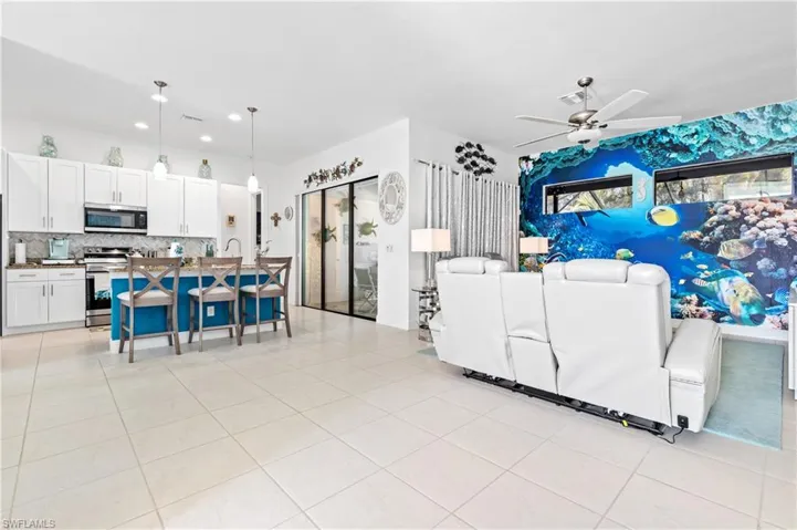 Living area featuring ceiling fan and light tile patterned flooring