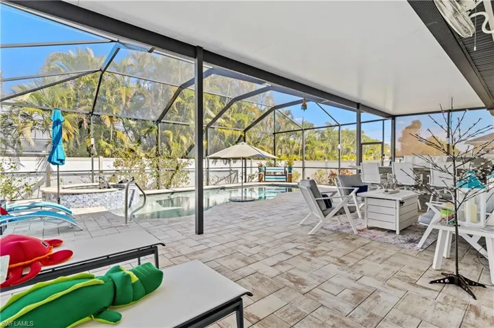 View of patio with a lanai and a sunroom