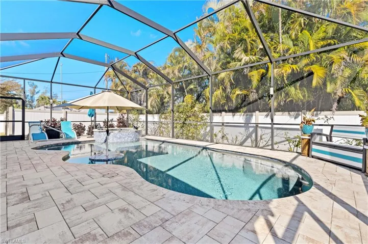 Combined pool / hot tub featuring a fenced backyard, glass enclosure, a sunroom, and a patio area