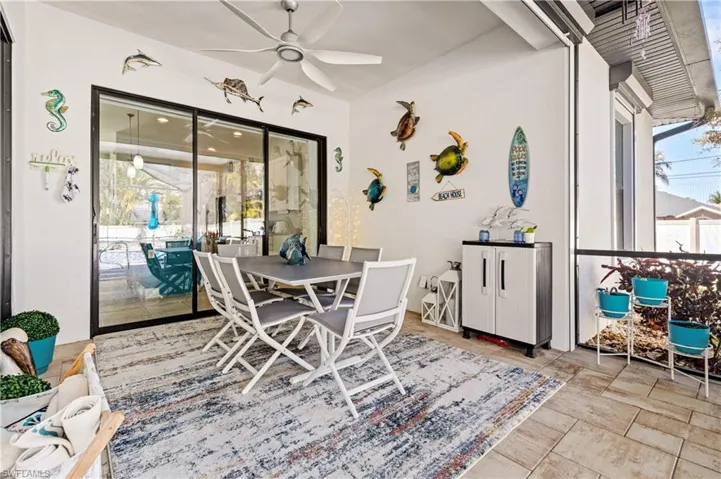 Dining room with ceiling fan and a sunroom
